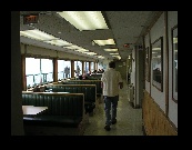 In the passenger lounge of the ferry, Marion has found the coffee machine